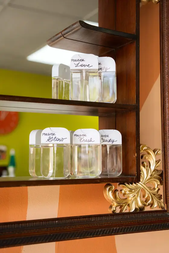 Shampoo and conditioner bottles on a shelf by the mirror